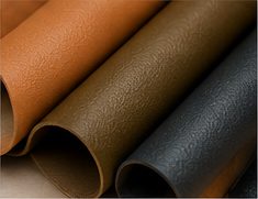 Rolls of vegan leather in tan, olive and charcoal