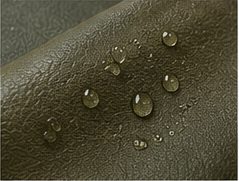Water droplets beading on olive vegan leather